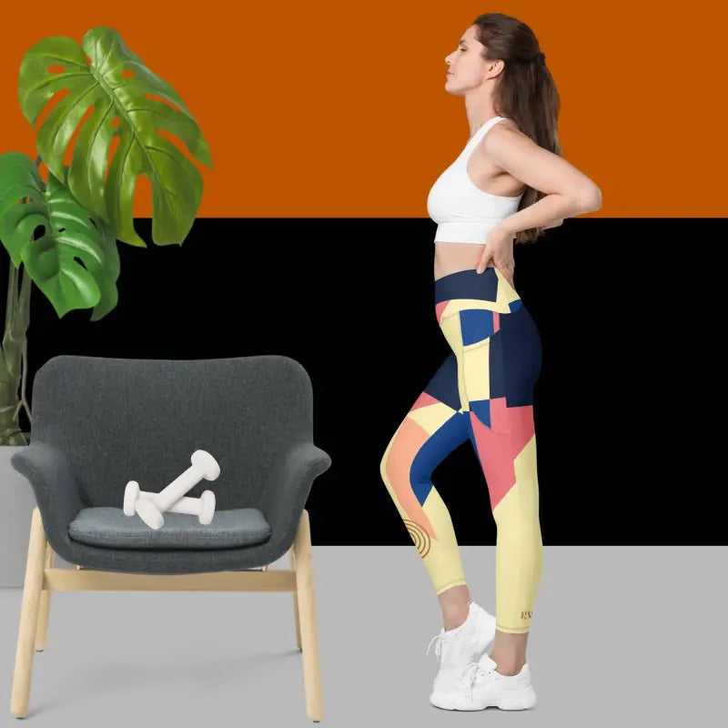 Athletic figure in colorful abstract pocket leggings and a white sports bra stretching