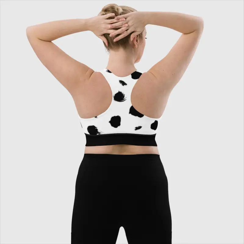 Black and white cow print longline sports bra paired with black leggings for stylish workouts