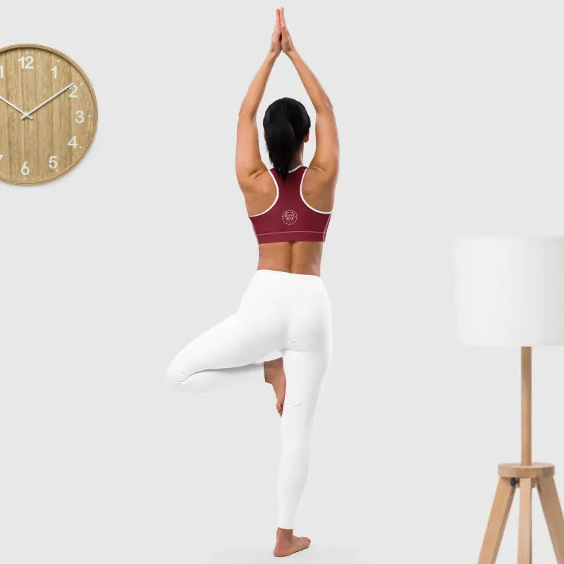 Woman in yoga pose wearing a Floral Padded Sports Bra for medium support during workouts