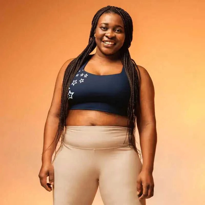 Plus size activewear: Navy Recycled Longline Sports Bra with star crop top and beige workout leggings