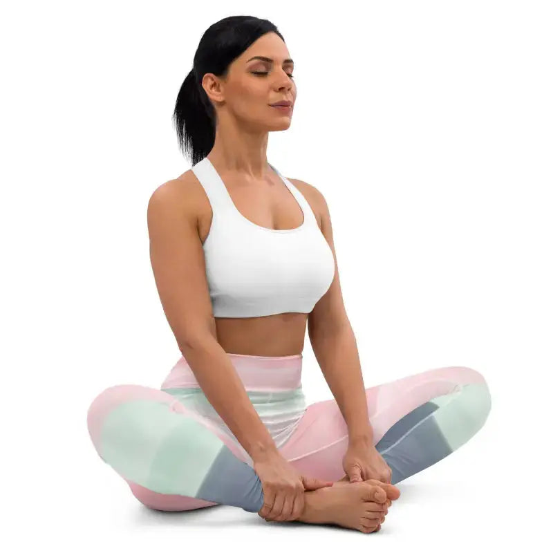 Woman in yoga pose wearing pastel rainbow striped yoga leggings for a stylish workout