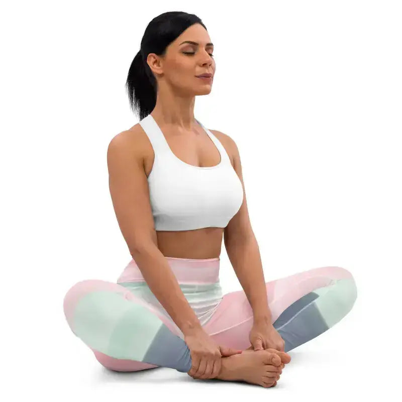 Woman in yoga pose wearing pastel rainbow striped yoga leggings for a stylish workout