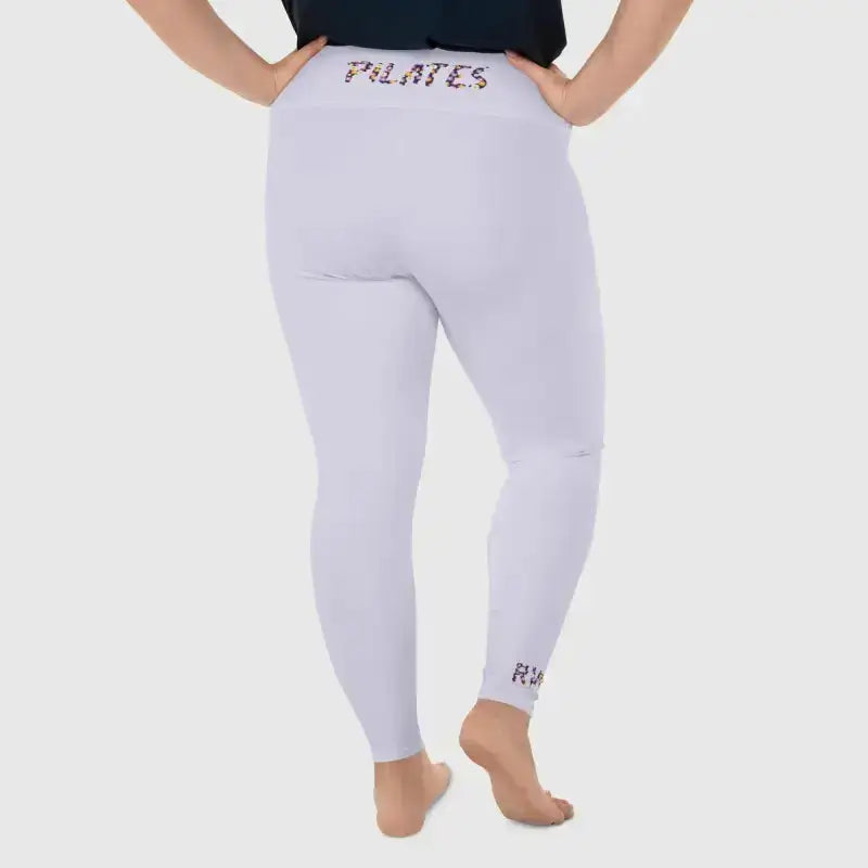 Back view of a person wearing comfortable plus size Pilates leggings with stylish text on the waistband.