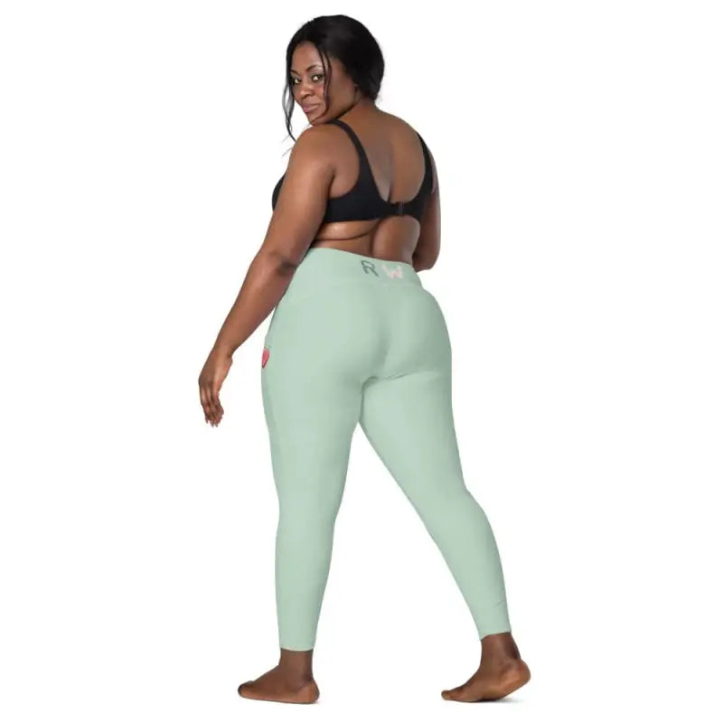 Mint green Revive Crossover Leggings with pockets and a fitted silhouette