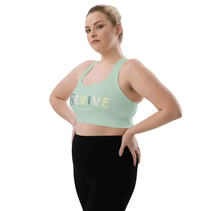 Woman wearing Revive Longline Sports Bra in Ocean Green, stylish longline sports bra