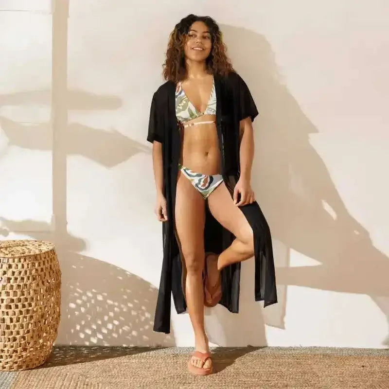 Woman in stylish string bikini swimwear set with cover-up for summer vibes