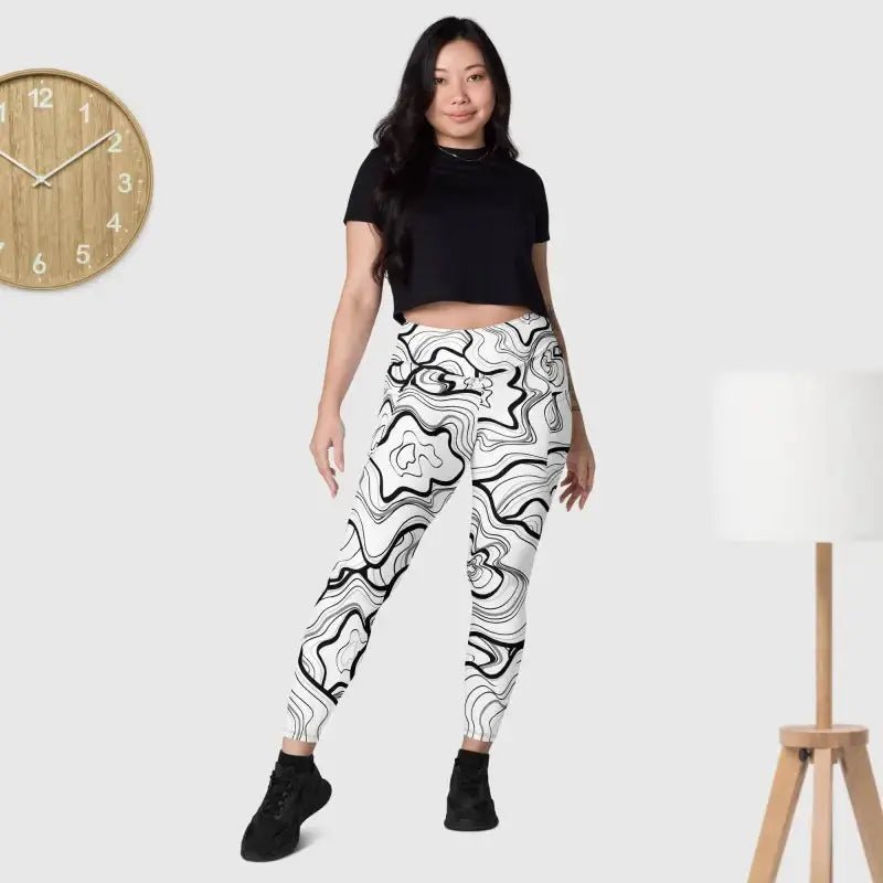Stylish black fitness leggings with a phone pocket paired with trendy white pants