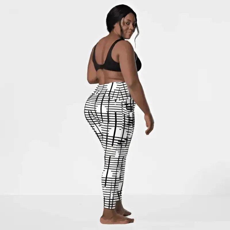 Black recycled crossover leggings with bold black and white geometric grid pattern