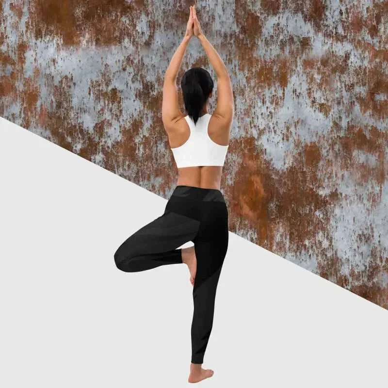 Person doing tree pose in black yoga leggings and white sports bra for yoga leggings style