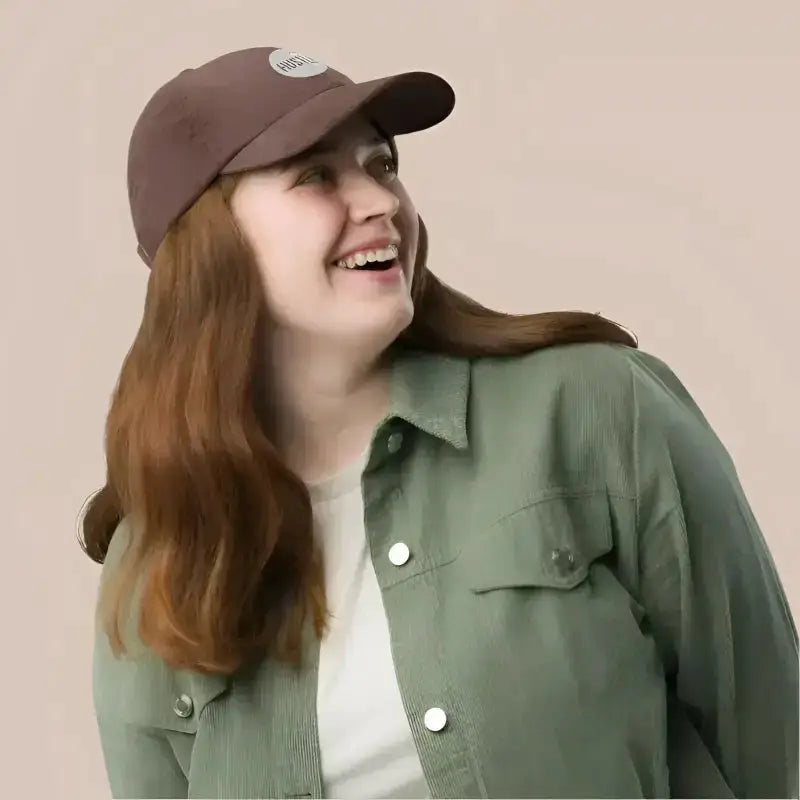Smiling woman in brown baseball cap wearing stylish corduroy hats and green jacket