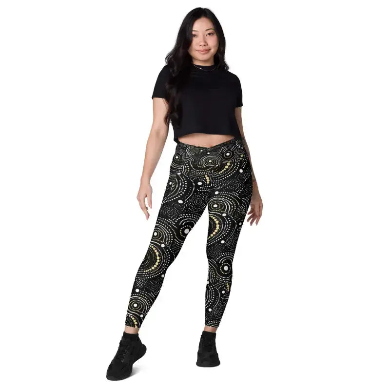 Woman wearing stylish crossover leggings in black and gold, perfect for workout and plus size activewear
