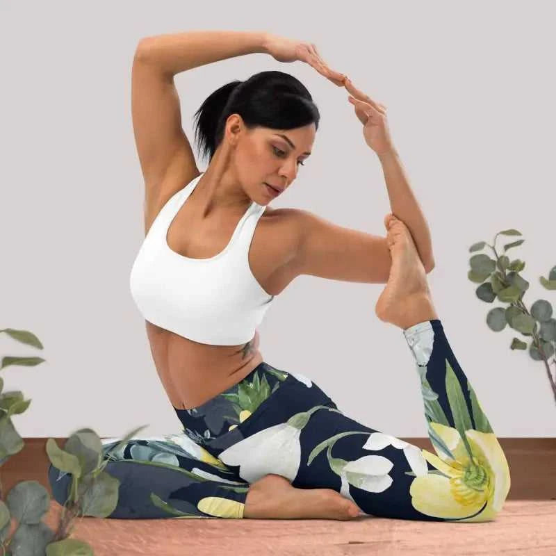 Woman in floral workout leggings doing yoga stretch in high waist leggings