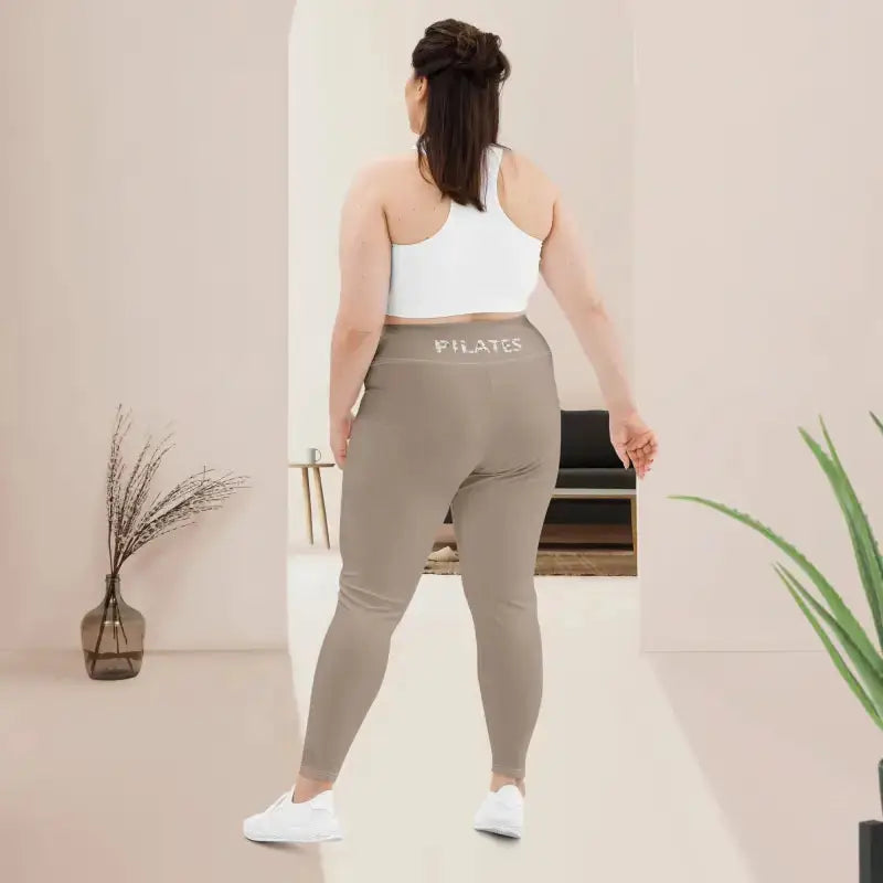 Woman wearing Khaki Plus Size Pilates Leggings with high waistband and stretch fabric