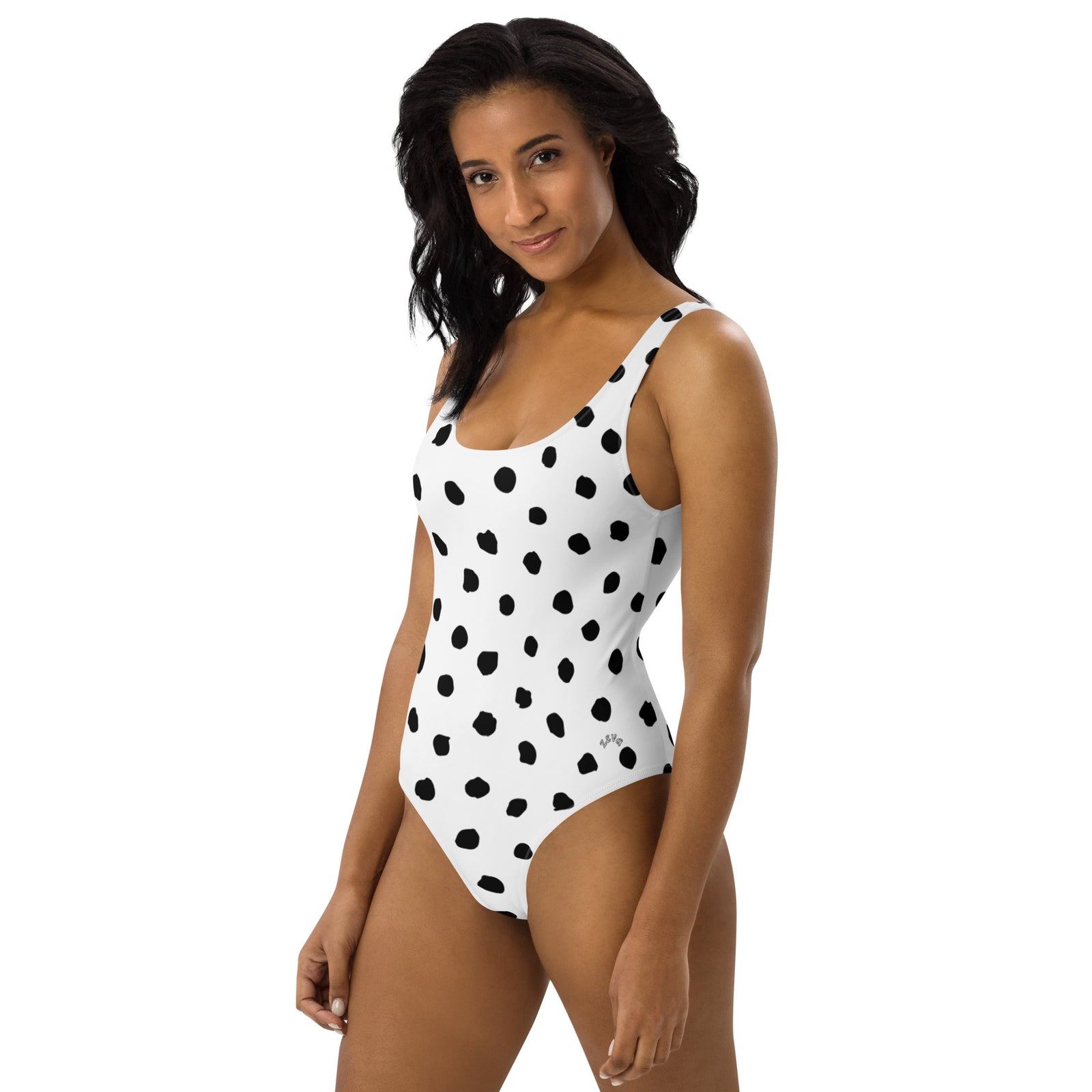 One-Piece Swimsuit in white with black poka dots, features scoop neckline and low cut back. Shop Zeva Swimwear today at Revive Wear.