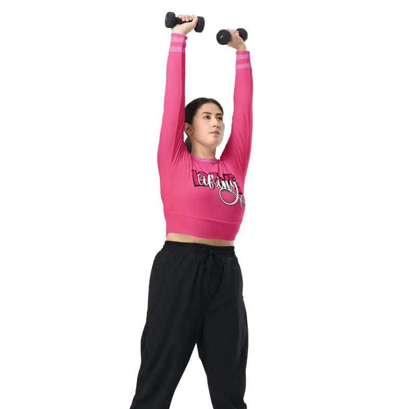 Someone exercising with dumbbells while wearing a pink crop top and black pants.