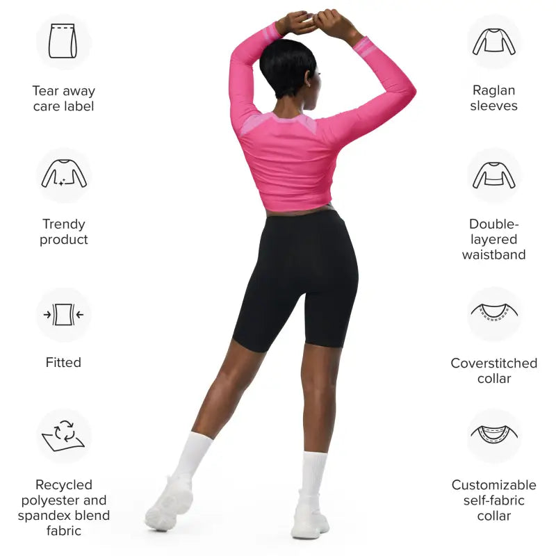 Pink long-sleeved athletic top paired with black cycling shorts.