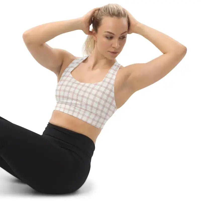 Woman wearing Pinstripe Recycled Longline Sports Bra in plaid sports bra and black leggings