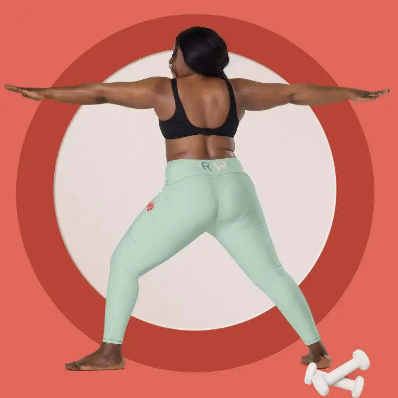 Person in mint green leggings with pockets doing a wide-stance exercise pose with dumbbells