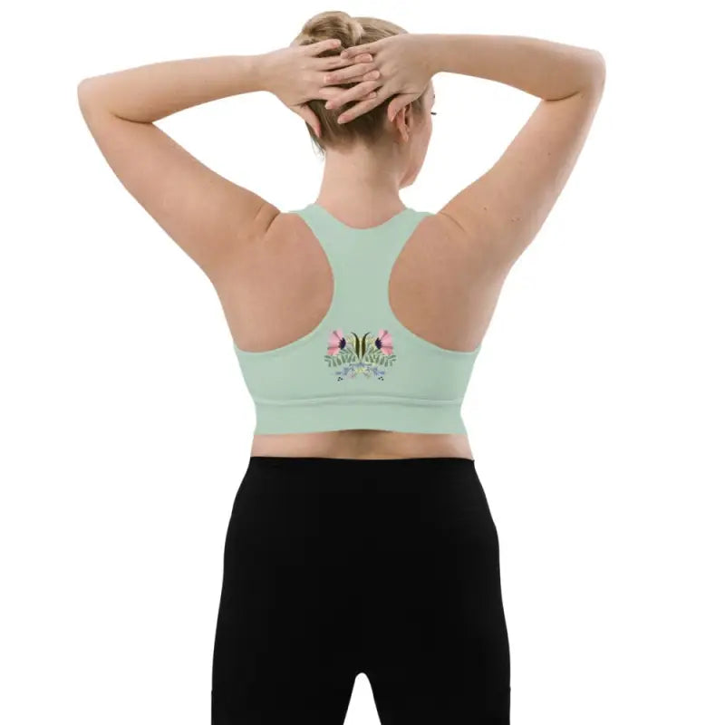Woman wearing Revive Longline Sports Bra in Ocean Green, perfect longline sports bra
