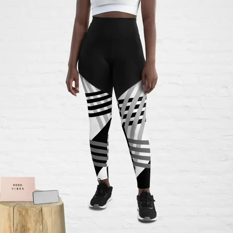 Sports Leggings with Phone Pocket in Black and White Print - Revive Wear Enhance your workouts with Revive Wear AU's Sports Leggings featuring a convenient phone pocket. Stay connected and stylish during your fitness routine. Shop now!