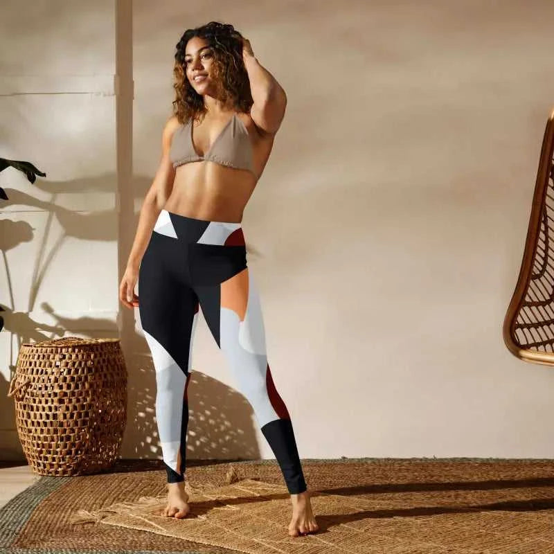 Geometric color-block printed tights featuring black, white, and burgundy panels for workouts