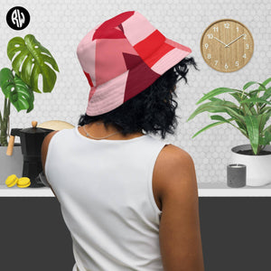 Women's reversible bucket hat with outside view of colors in pink and red.