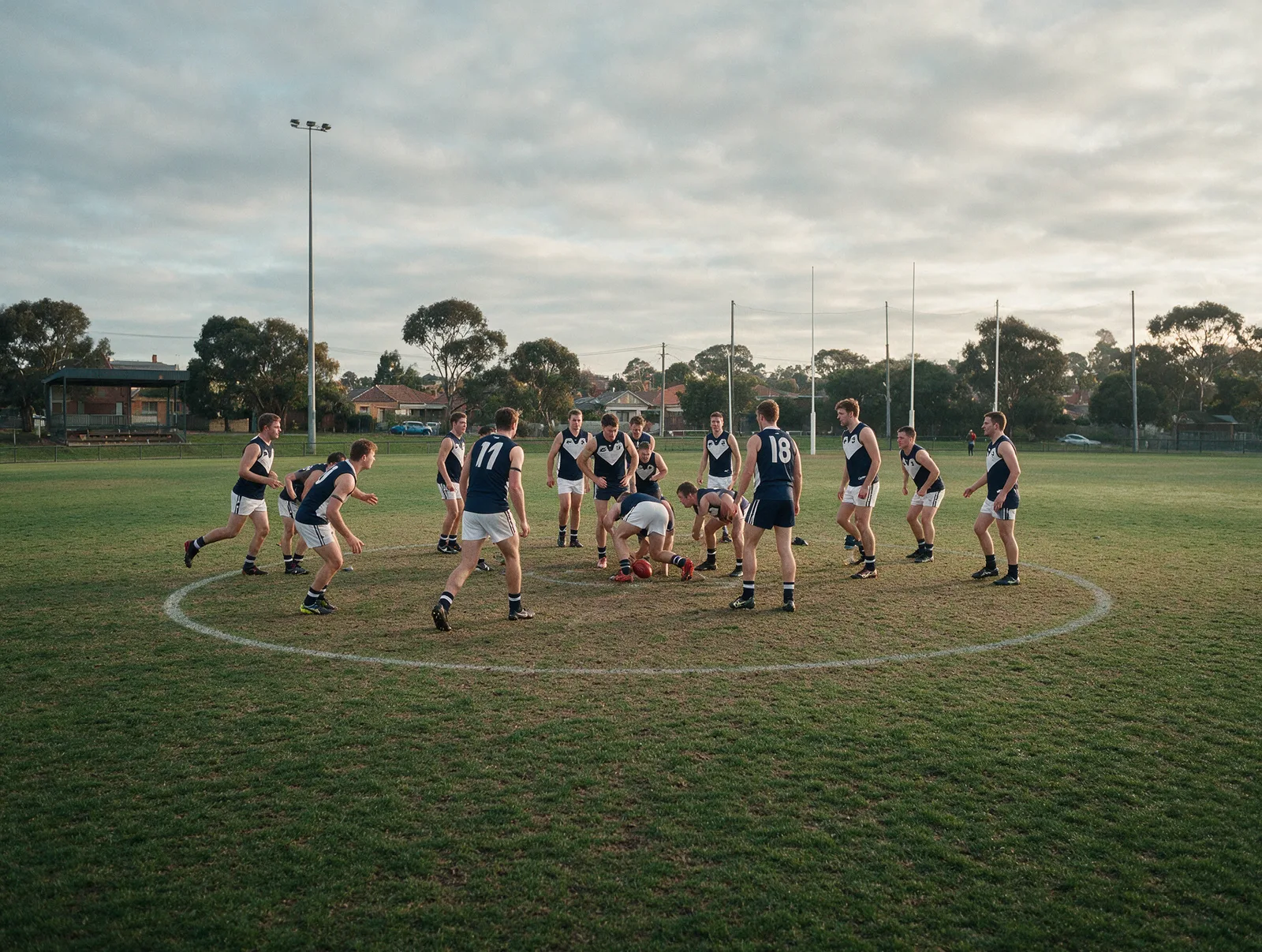 Australian rules football team warming up in matching guernseys in Melbourne